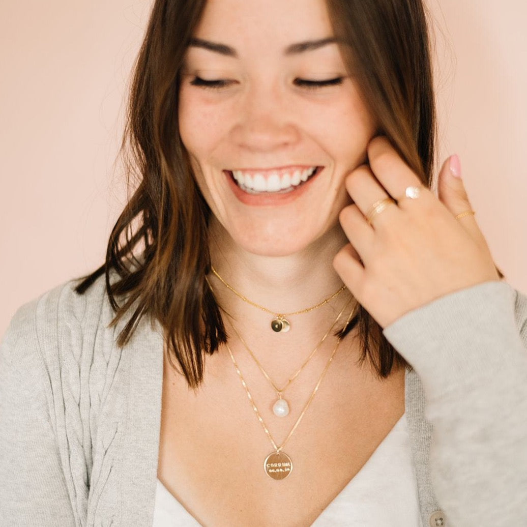 Woman wearing three custom handmade necklaces
