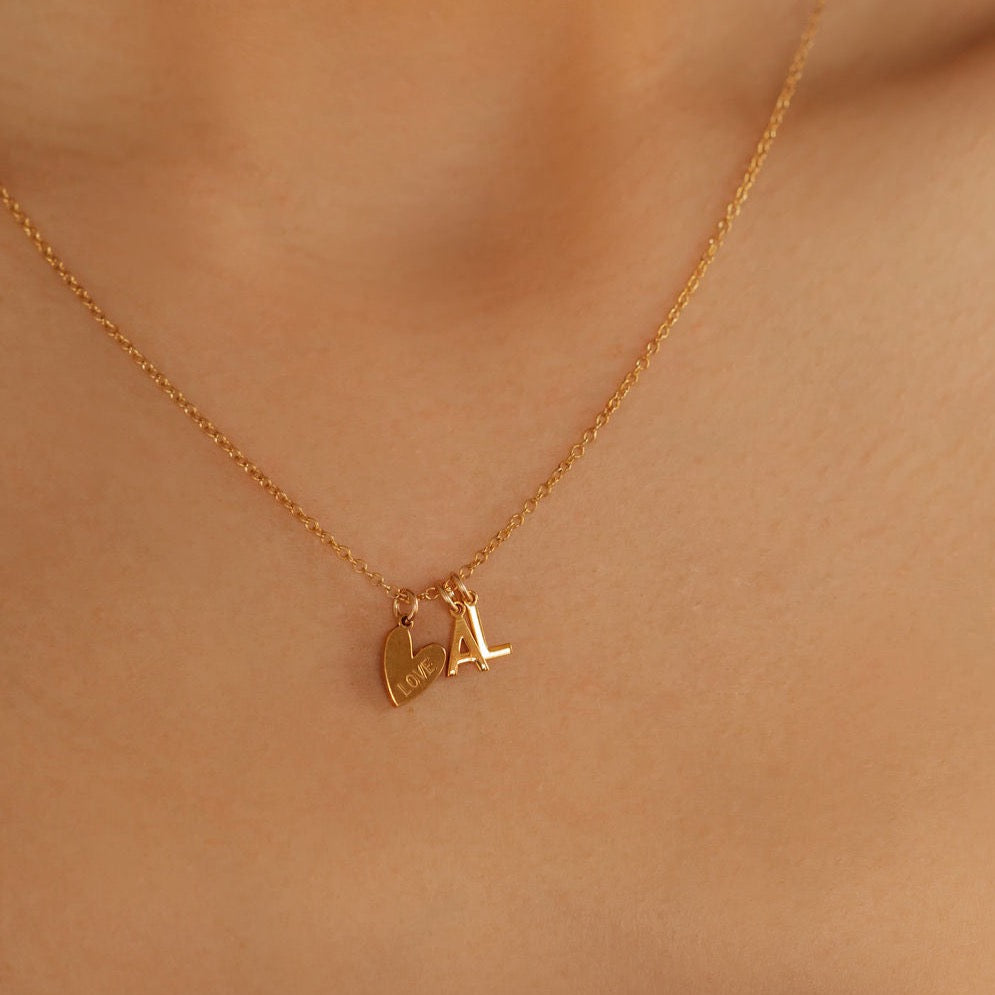 A gold heart and A L initial pendant necklace made in Canada
