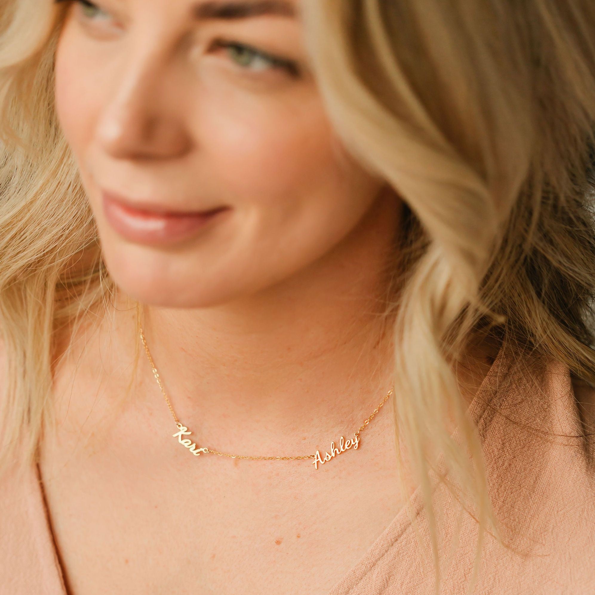 Model wearing multiple name necklace