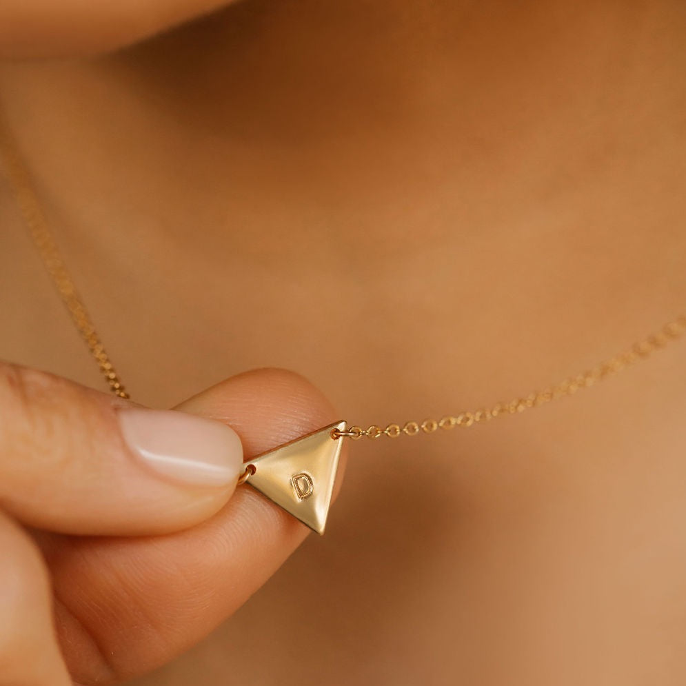 a small gold initial necklace made in Canada