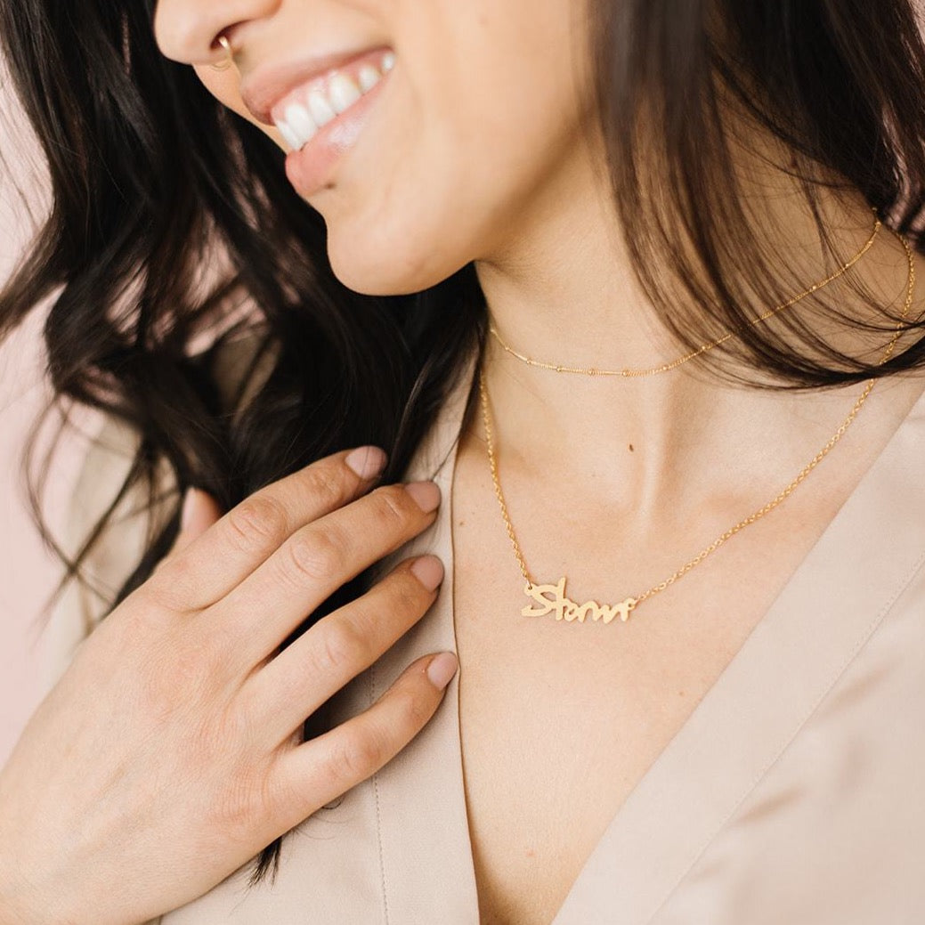 Woman wearing handmade gold choker and custom handwriting necklace